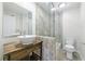 Well-lit bathroom featuring a stylish bowl sink, tiled floors and a glass shower at 13 Ivy Ne Sq, Atlanta, GA 30342