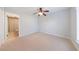 Large bedroom with plush carpet, ceiling fan, and a bathroom to the side at 13 Ivy Ne Sq, Atlanta, GA 30342