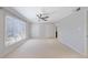 Bright bedroom featuring a ceiling fan, large windows and plush carpet at 13 Ivy Ne Sq, Atlanta, GA 30342