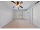 Bright bedroom featuring a ceiling fan, a window and a closet at 13 Ivy Ne Sq, Atlanta, GA 30342