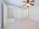 Spacious bedroom with plush carpet, ceiling fan, and closet at 13 Ivy Ne Sq, Atlanta, GA 30342