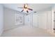 Large bedroom with plush carpet, ceiling fan, and good lighting at 13 Ivy Ne Sq, Atlanta, GA 30342