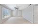 Bedroom with neutral carpet, ceiling fan, large window and double door closet at 13 Ivy Ne Sq, Atlanta, GA 30342