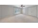 Bedroom with carpet, ceiling fan, large window and large double door closet at 13 Ivy Ne Sq, Atlanta, GA 30342