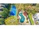 Aerial shot of the tennis court and covered community pool surrounded by lush greenery at 13 Ivy Ne Sq, Atlanta, GA 30342