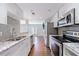 Modern kitchen features stainless steel appliances, granite countertops, and subway tile backsplash at 13 Ivy Ne Sq, Atlanta, GA 30342