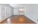 Spacious living room with hardwood floors, built-in shelving, and french doors at 13 Ivy Ne Sq, Atlanta, GA 30342