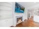 Living room view with hardwood floors and open access to kitchen with stainless fridge at 13 Ivy Ne Sq, Atlanta, GA 30342
