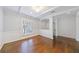 Bright living room featuring pristine white walls, a modern chandelier, and dark hardwood floors at 13 Ivy Ne Sq, Atlanta, GA 30342