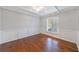 Bright living room featuring pristine white walls, a modern chandelier, and dark hardwood floors at 13 Ivy Ne Sq, Atlanta, GA 30342