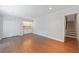 Spacious living room with hardwood floors, built-in shelving, and access to stairs at 13 Ivy Ne Sq, Atlanta, GA 30342