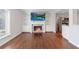 Living room featuring fireplace, built-in bookshelves, and adjacent kitchen at 13 Ivy Ne Sq, Atlanta, GA 30342