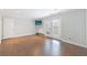 Large living room with hardwood floors, exterior access, and contemporary wall-mounted television at 13 Ivy Ne Sq, Atlanta, GA 30342