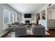 Bright living room boasts large windows, fireplace, built-in shelving and a view into the open kitchen at 13 Ivy Ne Sq, Atlanta, GA 30342