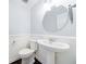 Charming powder room featuring a pedestal sink and modern fixtures at 13 Ivy Ne Sq, Atlanta, GA 30342
