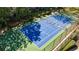 Aerial view of the community tennis court with benches and green surroundings at 13 Ivy Ne Sq, Atlanta, GA 30342