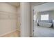 Bright bathroom view featuring a soaking tub, marble floors, and a wire rack walk-in closet at 2781 Dolce Rd, Dacula, GA 30019