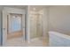 Bright bathroom view featuring a glass shower, marble floors and a walk way at 2781 Dolce Rd, Dacula, GA 30019