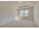 Carpeted bedroom with tray ceiling and windows providing natural light at 2781 Dolce Rd, Dacula, GA 30019