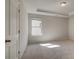 Bright bedroom featuring a tray ceiling, and neutral carpeting at 2781 Dolce Rd, Dacula, GA 30019
