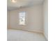 Empty bedroom with carpeted floors and natural light from the window at 2781 Dolce Rd, Dacula, GA 30019