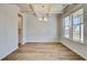 Bright dining room featuring coffered ceilings, wood floors, and a stylish chandelier fixture at 2781 Dolce Rd, Dacula, GA 30019