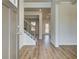 Inviting foyer with hardwood floors, neutral walls, and a staircase with black iron spindles at 2781 Dolce Rd, Dacula, GA 30019