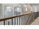 Upstairs hallway boasts wood and wrought iron railing and ample light at 2781 Dolce Rd, Dacula, GA 30019
