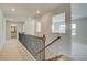 Upstairs hallway with decorative railing and views into the bedrooms and bathroom at 2781 Dolce Rd, Dacula, GA 30019