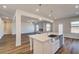 Modern kitchen island with stainless steel sink and pendant lighting overlooks the living space at 2781 Dolce Rd, Dacula, GA 30019