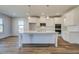 Modern kitchen with white cabinets, quartz countertops, a large island, and stainless steel appliances at 2781 Dolce Rd, Dacula, GA 30019