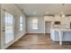 Bright eat-in kitchen features white cabinets, modern appliances, and wood-look flooring at 2781 Dolce Rd, Dacula, GA 30019