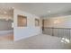 Open loft space with neutral carpet, natural light, and wrought iron railing at 2781 Dolce Rd, Dacula, GA 30019