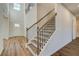 Elegant staircase with wood treads, iron spindles, and a light-filled landing leading to the upper level at 2781 Dolce Rd, Dacula, GA 30019