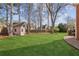 The backyard offers a lush lawn and storage building, perfect for outdoor activities at 321 Covered Bridge Sw Pl, Smyrna, GA 30082