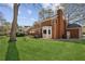 The expansive backyard showcases the brick home's architectural charm and outdoor living spaces at 321 Covered Bridge Sw Pl, Smyrna, GA 30082