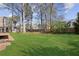 Spacious backyard with lush green grass, mature trees, privacy fence and storage shed at 321 Covered Bridge Sw Pl, Smyrna, GA 30082