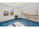 The sunny bedroom has blue carpet, white walls, and an open loft area at 321 Covered Bridge Sw Pl, Smyrna, GA 30082