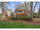 Charming brick home featuring a well-kept lawn, lush landscaping, and mature trees at 321 Covered Bridge Sw Pl, Smyrna, GA 30082