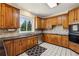 Traditional kitchen with oak cabinets, stainless steel appliances, and a stone tile backsplash at 321 Covered Bridge Sw Pl, Smyrna, GA 30082