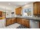 Bright kitchen with oak cabinets, black countertops and stainless steel appliances at 321 Covered Bridge Sw Pl, Smyrna, GA 30082