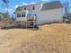 Spacious backyard featuring a two-story home with a patio and tiered landscaping at 8470 Wallace Tatum Rd, Cumming, GA 30028