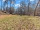 Expansive backyard area with trees and open space, offering room for outdoor activities and recreation at 8470 Wallace Tatum Rd, Cumming, GA 30028
