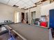 Basement with a pool table, kitchenette and popcorn machine; partially unfinished ceiling at 8470 Wallace Tatum Rd, Cumming, GA 30028