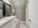 Stylish bathroom featuring double sinks with granite countertops and patterned tile flooring at 8470 Wallace Tatum Rd, Cumming, GA 30028