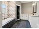 Open bathroom featuring a soaking tub, tiled shower, and granite topped vanity at 8470 Wallace Tatum Rd, Cumming, GA 30028