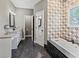 Elegant bathroom with a soaking tub, shower, and double vanity sinks at 8470 Wallace Tatum Rd, Cumming, GA 30028