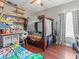 bedroom with a unique bunk bed, wood floors, and lots of shelving at 8470 Wallace Tatum Rd, Cumming, GA 30028
