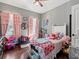 bedroom with wood floors, pink curtains, and a cozy atmosphere at 8470 Wallace Tatum Rd, Cumming, GA 30028