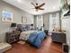 Comfortable bedroom with wood floors, ceiling fan, and ample natural light at 8470 Wallace Tatum Rd, Cumming, GA 30028
